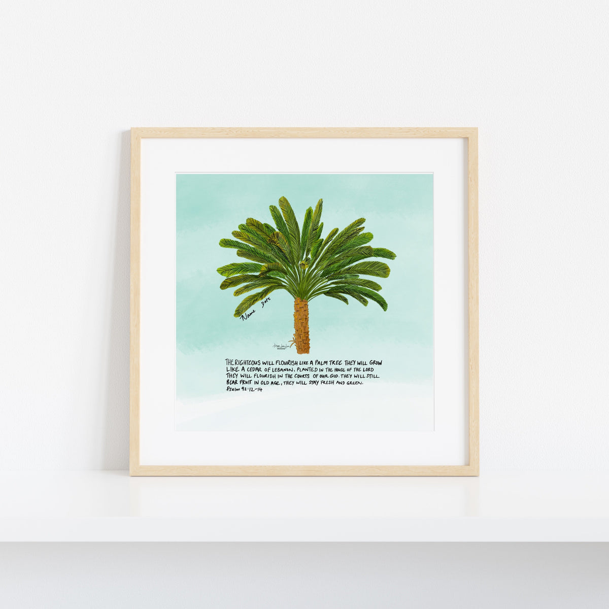 A framed art print featuring a watercolor-style green palm tree on a light aqua background, with a short poem printed below. The print is displayed in a light natural wood frame against a clean white wall.